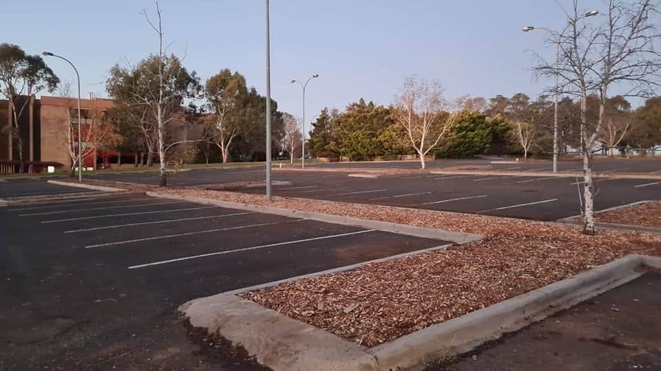 Freshly mulched garden beds at an institutional car park