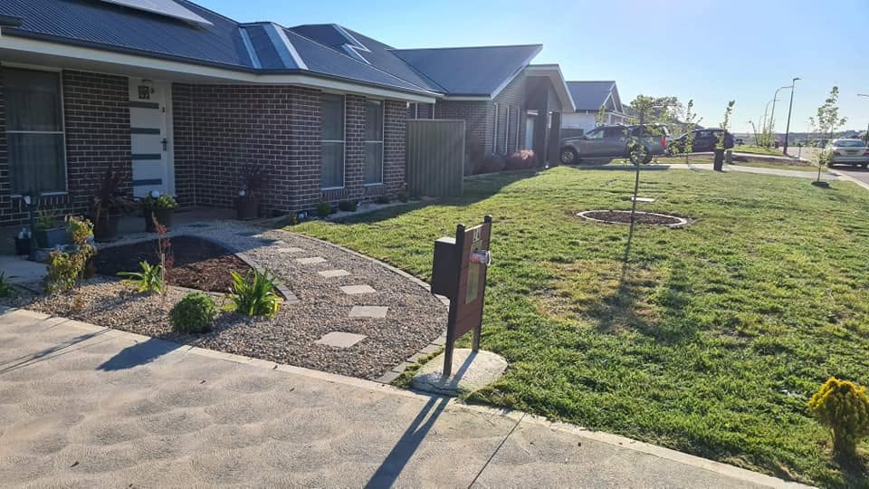 Established residential front yard with garden bed and lawn