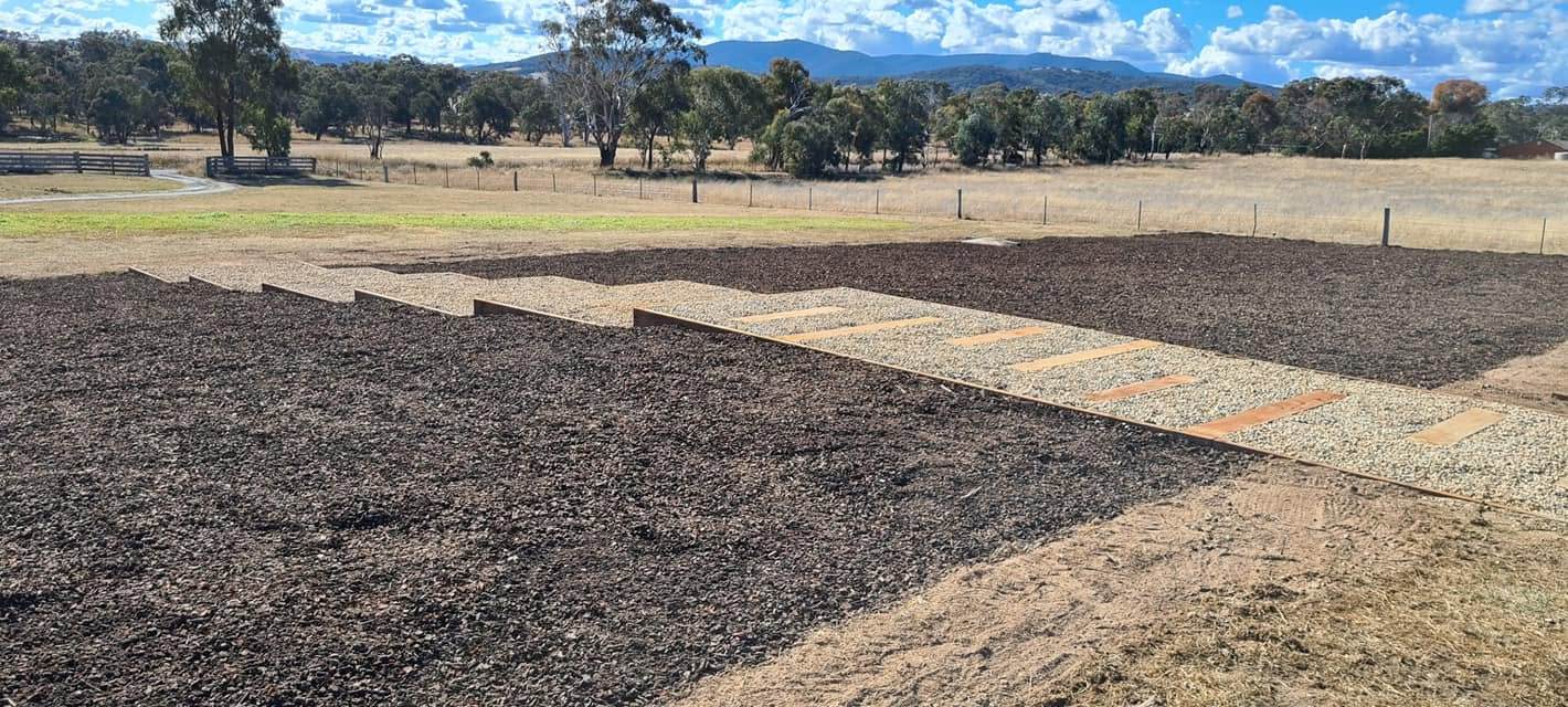 Landscaped gravel pathway and garden bed on a rural property